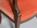 a wooden chair with a red upholstered seat