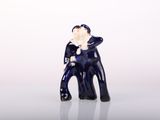 a small figurine of a man sitting on a chair