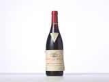 a bottle of red wine sitting on top of a table