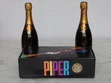 two bottles of champagne sitting on top of a black box