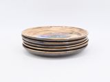 four plates stacked on top of each other on a white surface