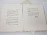 a open book on a table with a bookmark on top of it