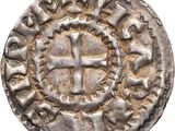 an old silver coin with a cross on it