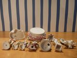 a table that has a lot of small ceramic objects on it
