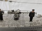 two figurines of men standing on a ship