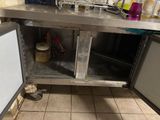 a kitchen with a sink and a refrigerator in it