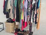 clothes hanging on a rack in a room with wooden floors