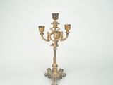 brass candelab with three candle holders on a white background
