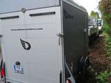 a trailer that is parked on the side of the road