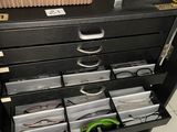 a black filing cabinet with a lot of files on it