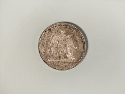 an old silver coin with a picture of a woman on it
