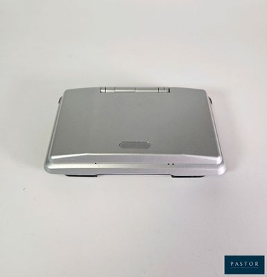 a silver electronic device sitting on a white surface