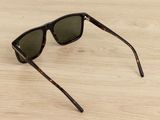 a pair of sunglasses sitting on top of a wooden table