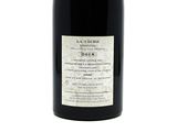 a bottle of wine that is sitting on a table