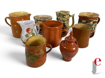 many different types of jugs and cups on the table