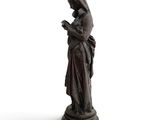 statue of a woman reading a book on a white background