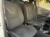 the interior of a white car with two black seats and a steering wheel