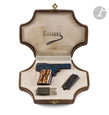 a wooden case with a gun and a magazine inside of it