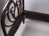 a wooden bed with a metal headboard and foot board