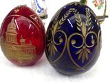 two decorative eggs sitting next to each other on a table