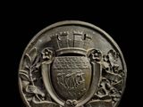 a close up of a coin with a coat of arms on it