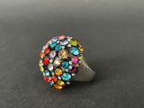 a close up of a colorful ring on a black surface