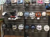 many helmets on display on the wall in the store