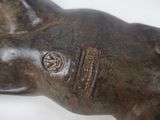 a statue of a dog with a tag on it ' s collar