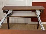 a desk with a drawer underneath it in a room