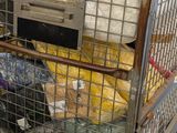a cage with a bunch of items inside of it