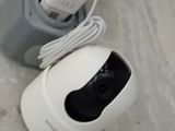 a white camera sitting on the floor next to a white box