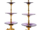 two tiered glass cake stands with gold trimmings and a purple glass plate