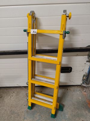 two yellow ladders sitting next to each other in front of a garage door