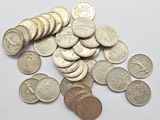 a pile of coins on a table with a white background