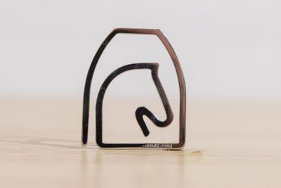 a close up of a small metal object on a wooden surface