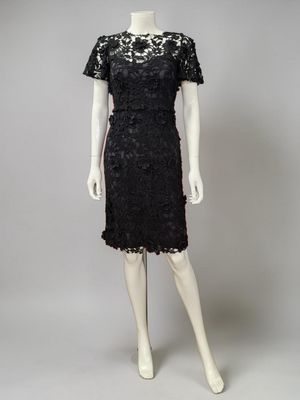 a black lace dress with short sleeves and a short skirt