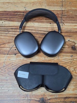 an image of a pair of black headphones on a wooden floor
