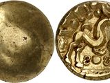 a close up of a gold coin with an image of a man on a horse