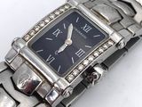 a silver watch with a black face on a silver bracelet