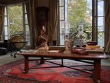 a living room with a red rug and a large window