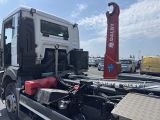 a truck that is parked in a lot with other trucks