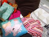 un tas de vêtements et d'oreillers par terre
