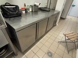 a kitchen with stainless steel counter tops and stainless steel cabinets