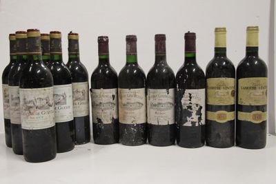 several bottles of wine are lined up in a row on a table