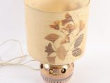 a lamp that is sitting on a table with a lamp shade on it