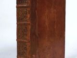 an old book sitting on top of a table next to a white background