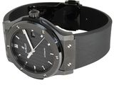 the watch is black and has a black rubber band