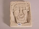 a stone sculpture of a man ' s face on display