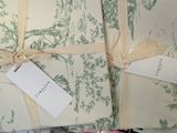 a pile of wrapping paper with a tag tied to it