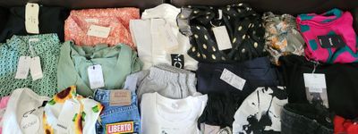 a suitcase full of clothes and other items on the floor
